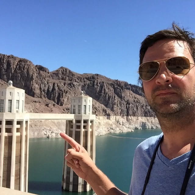 Dennis Goedegebuure at Hoover Dam, pointing at the intake towers